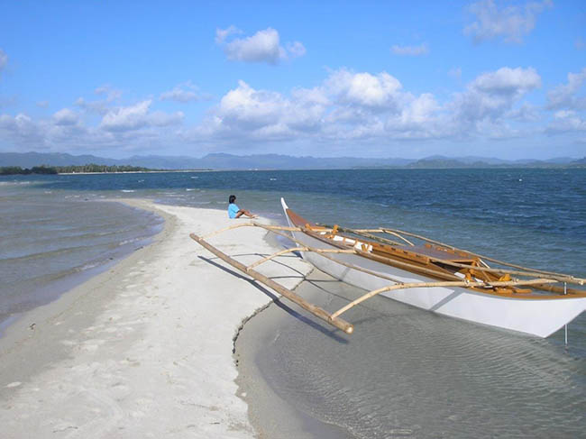 Beachfront Private Resort Near Lucena City coconut trees studded south facing sandy beach.